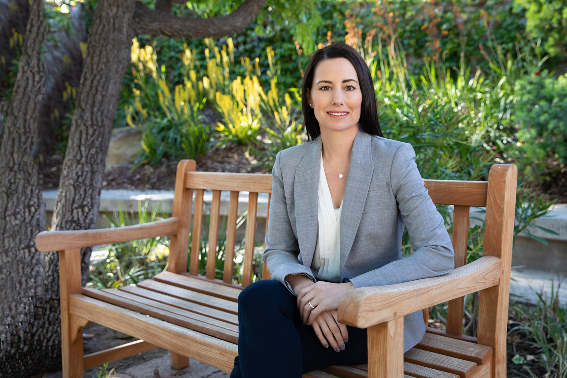Dr Danielle Greg on a bench at Pepperdine University posing for her portrait